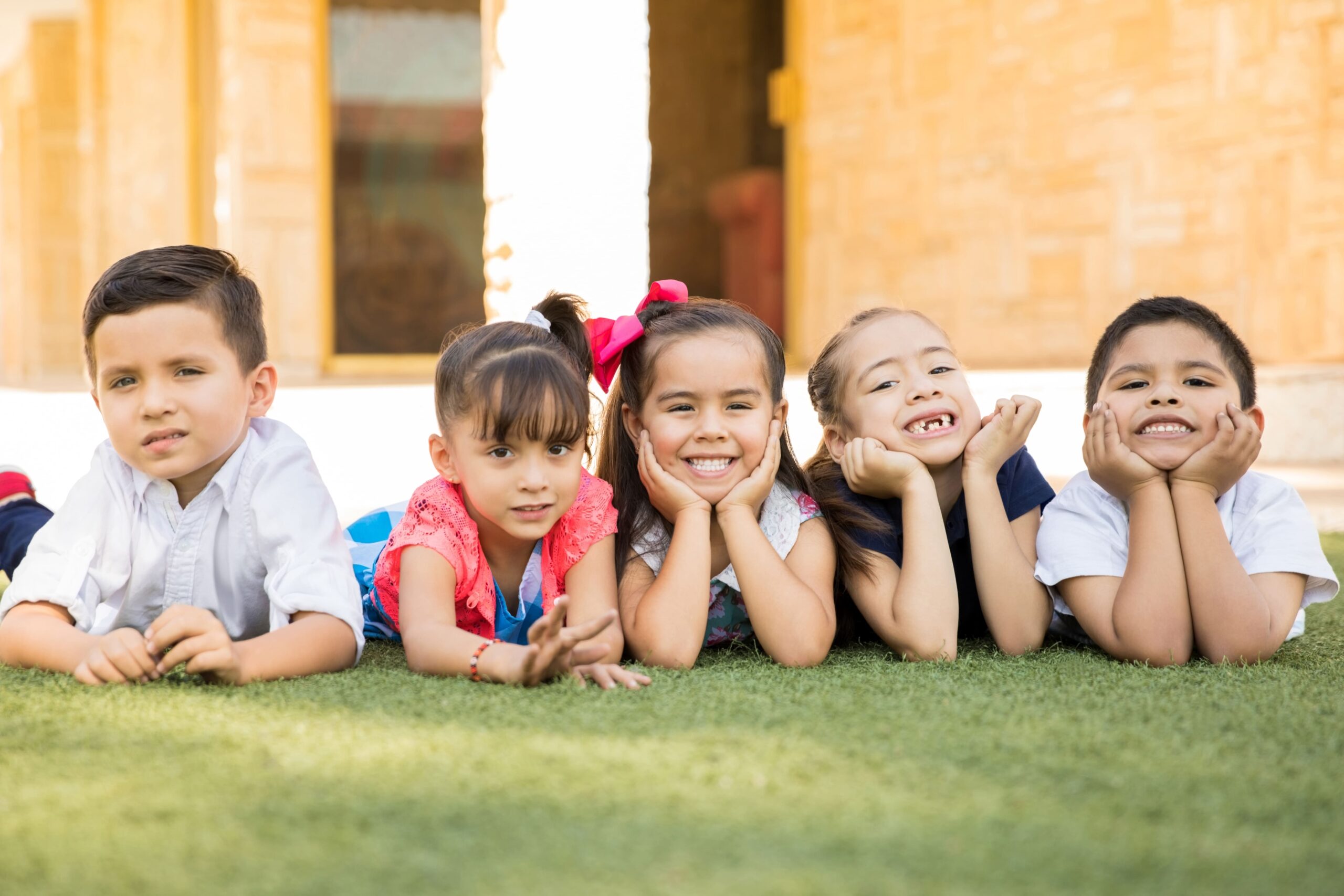 lindo-grupo-amigos-preescolar-tirados-pasto-sonriendo-pasando-buen-rato-juntos (1)